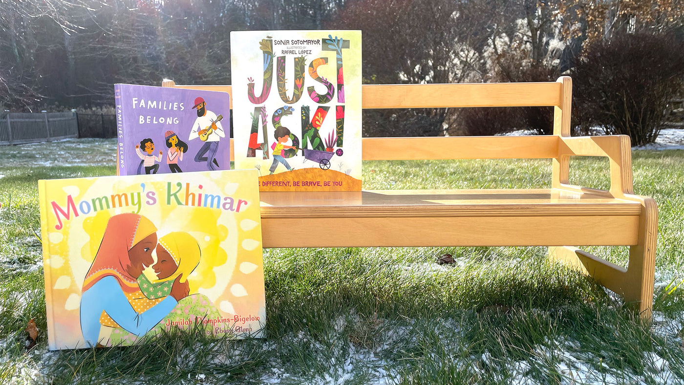 Diverse Children's Books Standing Outside on a Bench