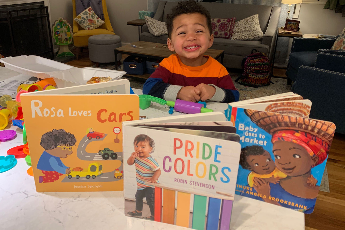 Happy Child Smiling with his LGBTQ+ Books