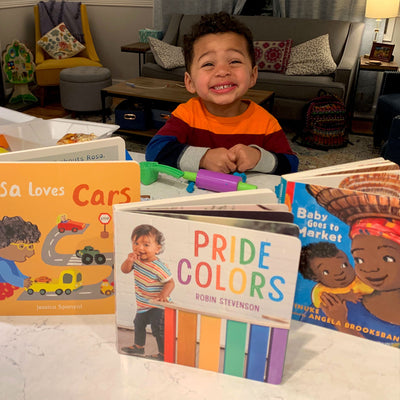 Infant Smiling with Baby Books